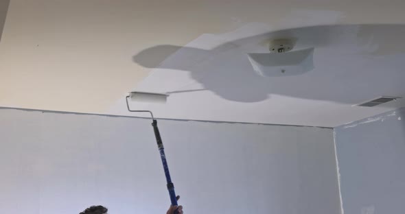 Painting of Ceiling in a Primer on White Color Repair in a House