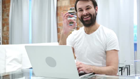 Sign of Okay Gesture By Young Beard Man