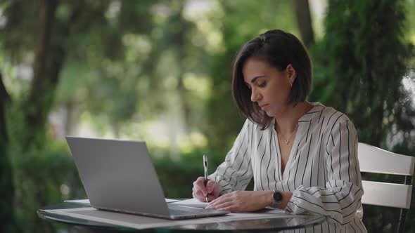 Student Woman Brunette Arabic Hispanic Ethnos Studying Remotely Via the Internet While Sitting in a