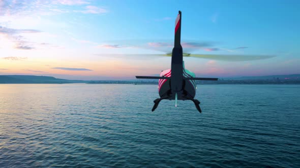 Helicopter Flying Over The Sea