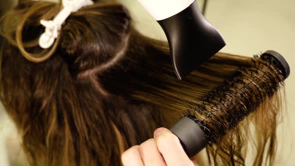 Woman Master Makes Hairstyle to Long Haired Client in Salon