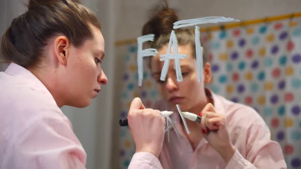 Young Slim Stressed Woman Writing Fat Word on Bathroom Mirror