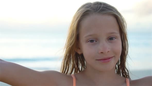 Adorable Little Girl Making Selfie at Tropical White Beach. SLOW MOTION