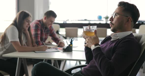 Boss is Talking to Employees at a Meeting