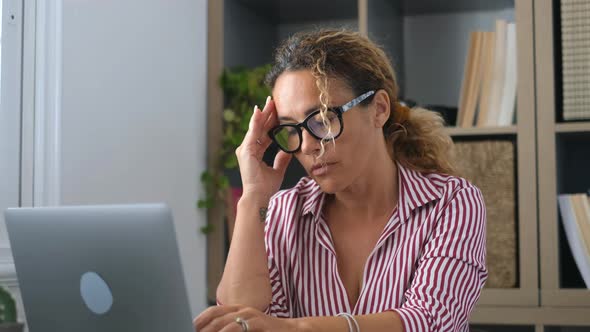 Unhealthy stressed businesswoman taking off eyeglasses, rubbing eyelids, suffering from dry eyes