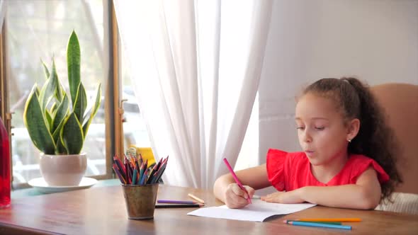 Happy Little Girl or Cute Primary Child School Child of 7-8 Years Old at Home Relaxing Sits in House