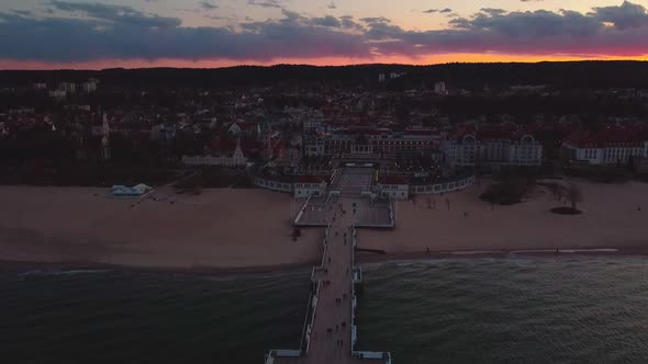 Cinematic pier in the sunset from a bird's eye view. Filming at sunset in Sopot.