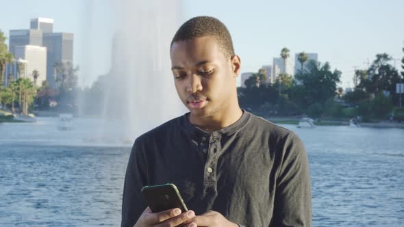 Young African American Man Using Cellphone in Los Angeles