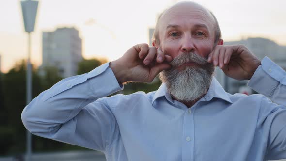 Funny Old Man Laughs Cheerfully Cares About Combing Gray Mustache and Beard Visits Hairdresser and