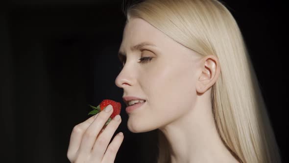 Attractive Woman Eating Strawberry