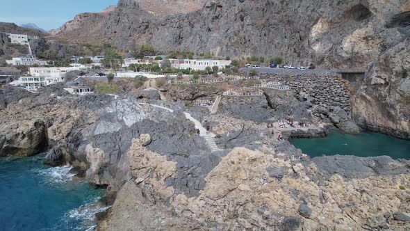 Drone footage of the Kalupso wild beach, Cretan village blue logons, coral reefs, rocky hills.