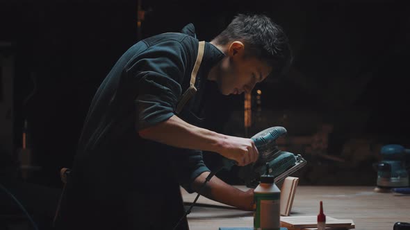 Side View Cinematic Video of a Carpenter at Work in a Carpentry Workshop