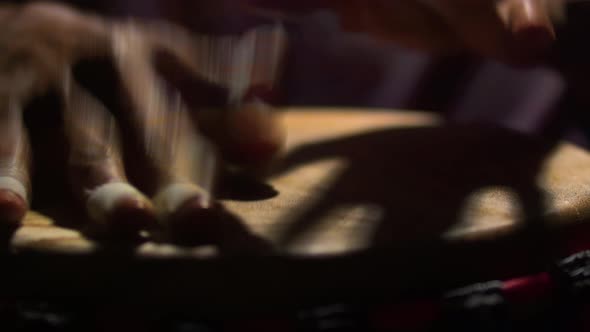 Black musician plays with hands on drum. On the African drum man beat the rhythm with hands