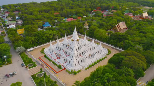 Aerial view of white pagoda or stupa of Asok Maharat buddhist Temple at sunset, Samut Prakan