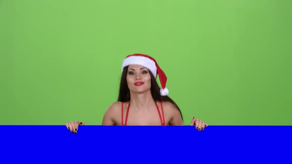Santas Assistant Looks Out of the Blue Board and Shows a Thumbs Down. Green Screen. Slow Motion