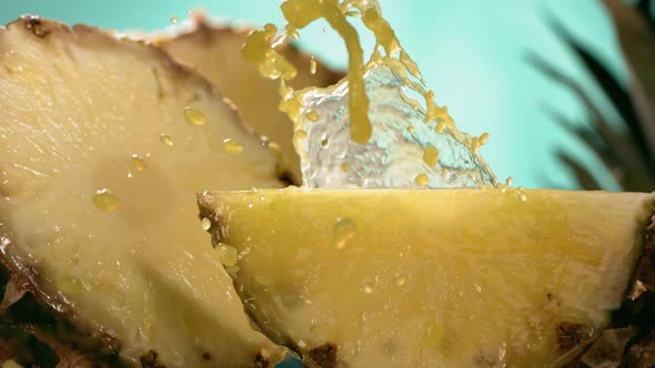 Slow Motion Shot of Pineapple and Juice Splashing Through Pineapple Slices