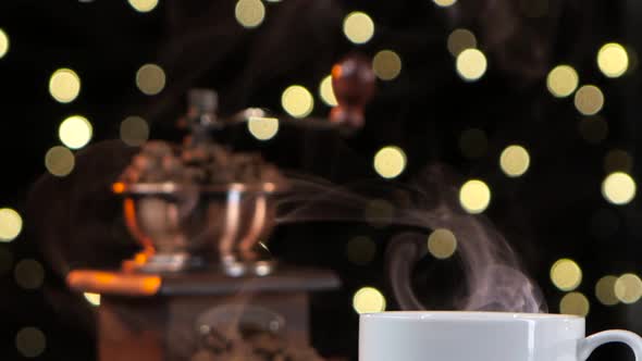 Closeup Smoke with a White Cup. Coffee Mill with Beans