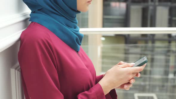 Closeup of the Hands of the Muslim Girls Use a Smartphone