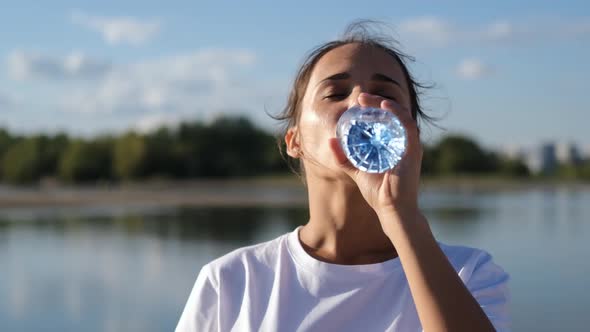 Brunette Woman Drinks Water From a Bottle After Workout, Outdoor Sports