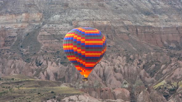 Hot Air Balloon Flying Over Hoodoos and Fairy Chimneys in Goreme Valley Cappadocia, Urgup Turkey