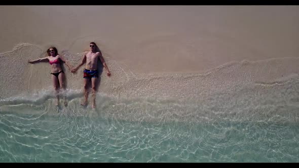 Young couple in love on paradise sea view beach holiday by aqua blue water and white sandy backgroun