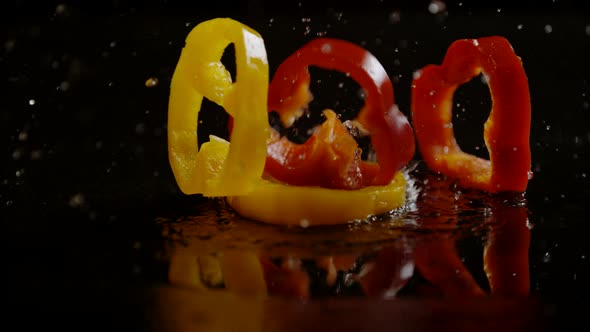 Slices of bell peppers falling on wet surface, Ultra Slow Motion alt