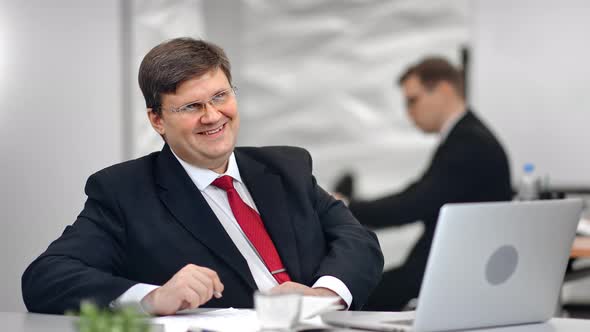 Happy Business Man in Suit Smiling Posing at Desk During Working on Laptop