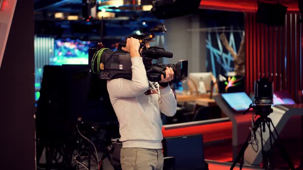 Making TV Show Or Film. Cameraman Working In TV Studio Video Production Filming Interview.