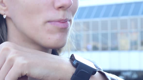 Woman Talking On The Phone Using A Smart Watch