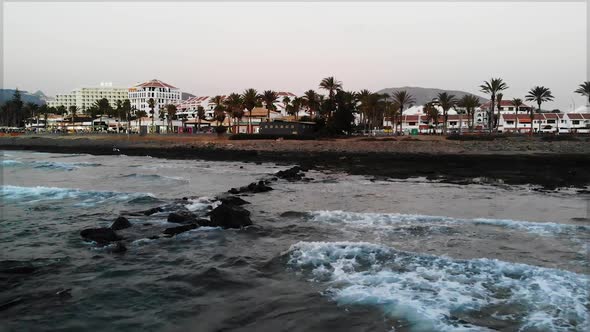 Small calm waves hitting the shoreline at Los Americas, Tenerife.