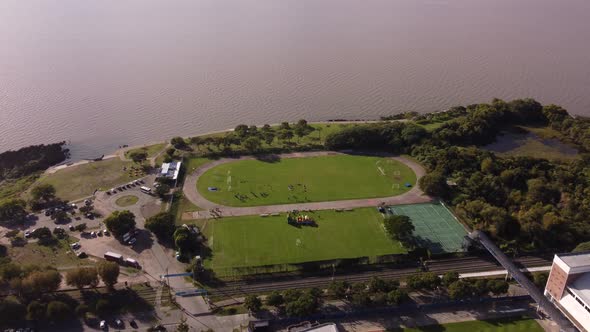 People training at waterfront soccer field in front of Rio De La Plata river in Buenos Aires, Argent
