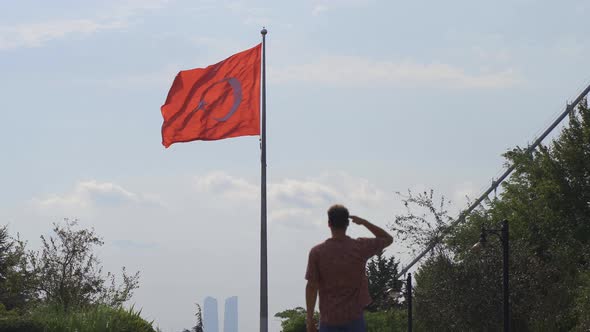 Man saluting the Turkish flag.