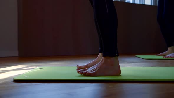 Female Bare Feet on Gym Mats. Women Squat. the Camera Moves Around