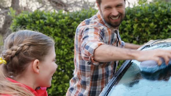 Happy daughter and father washing car with sponge 4K 4k