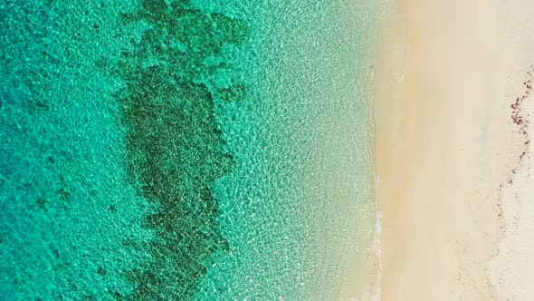 Wide angle flying copy space shot of a white sandy paradise beach and blue sea background in colorfu