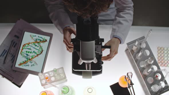 Biotechnology Scientists Looking into Microscope