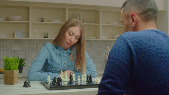 Confident Pretty Woman Defeating Male Opponent During Chess Game Indoors