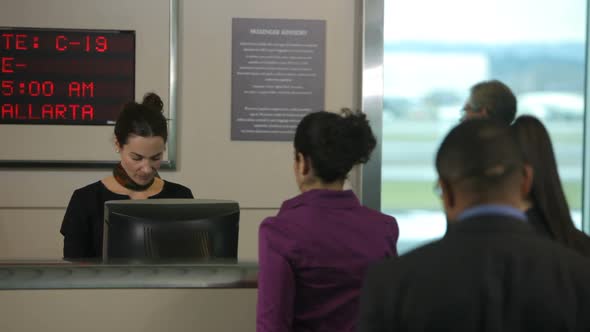 Airport passengers check in at ticket counter