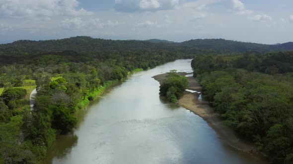 Aerial Drone View of Rainforest River and Mountains Scenery in Costa Rica at Boca Tapada, San Carlos