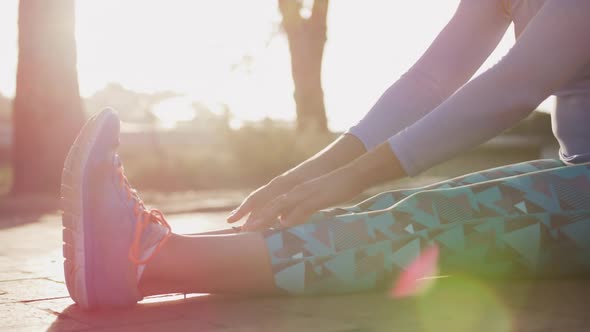 Caucasian woman stretching in a park