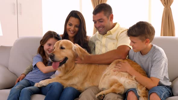 Happy family smiling with their dog