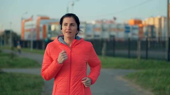 Fitness Young Woman Jogging in the City Park