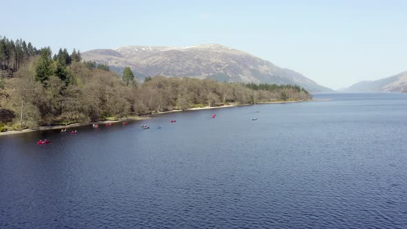 Canoeists in Scotland in a Loch Surrounded by Beautiful Landscape