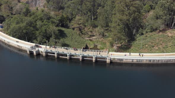 Fly over barrage in Munnar, India. People and cars crossing over.