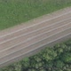 An Aerial View Shot By a Drone of the Tractor Harvesting Grass and Packaging It Into Neat White - VideoHive Item for Sale
