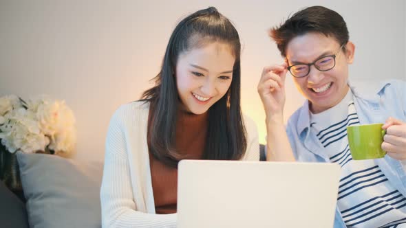 lovely asian young marry couple family enjoy leisure time with laptop