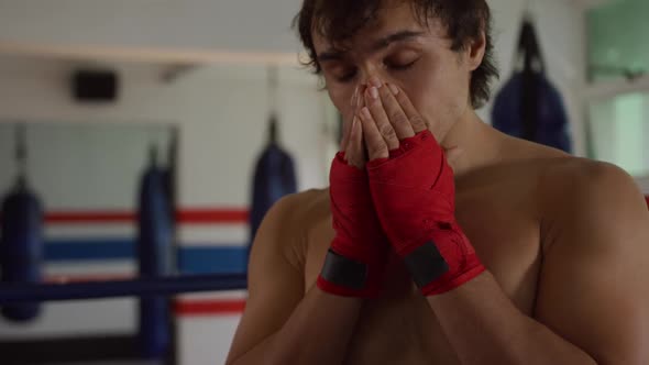 Thoughtful caucasian man in boxing ring