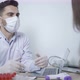 Doctor wearing protective mask use infrared forehead thermometer to check patient body temperature. - VideoHive Item for Sale