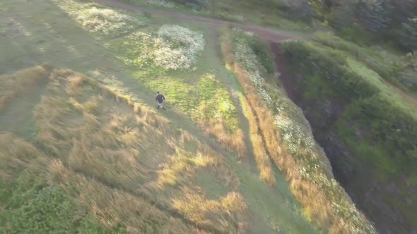 A trail runner reaches the end of a scenic ocean-side trail.