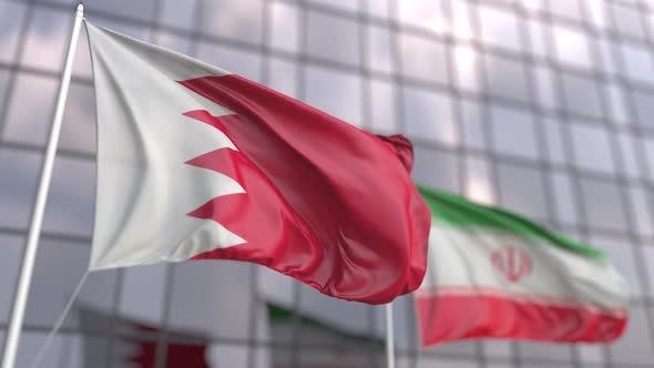 Flags of Bahrain and Iran in Front of a Skyscraper